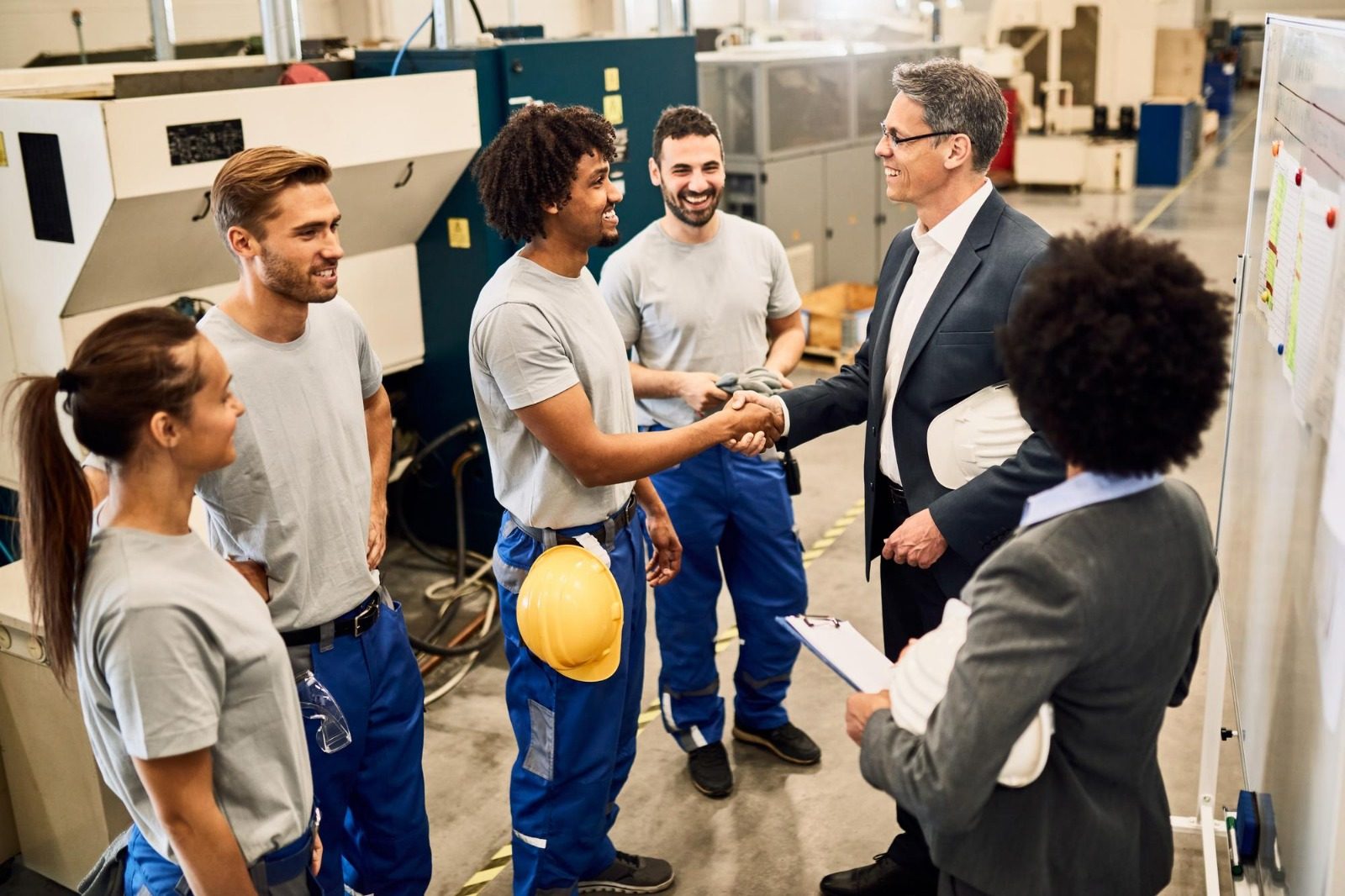 An industry leader shaking hands with a technical trainee