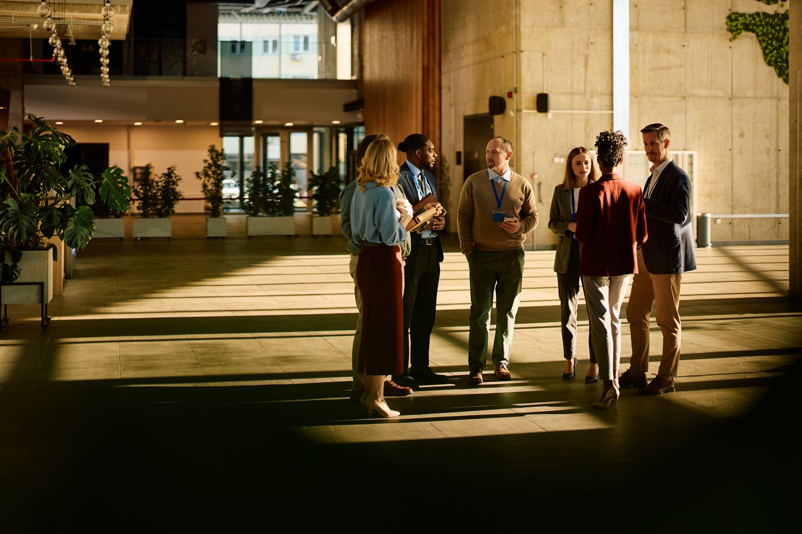 Delegates networking with lanyards in a conference venue